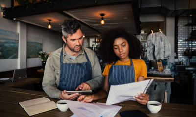 Business partners are reviewing their latest invoices to check for price rises