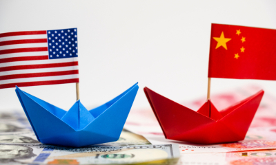 Paper boats representing the USA and China trade tariffs