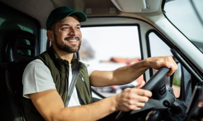 A small business owner driving his company van