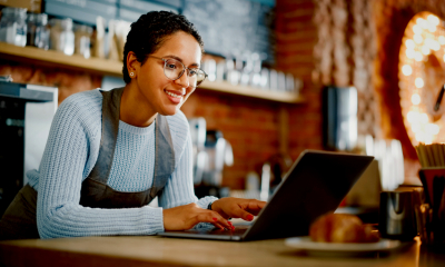 A cafe owner updates her digital signage