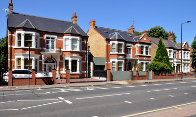 Multiple detached properties by the road on a sunny day