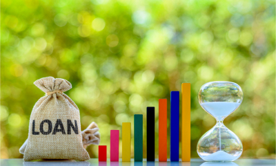A cloth sack with the word loan written on it and an egg timer