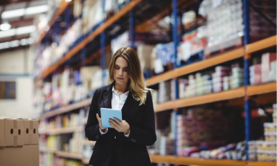 Businesswoman using tablet in warehouse