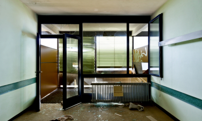 Empty white shop which has been damaged