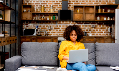 A woman works from home on her personal laptop