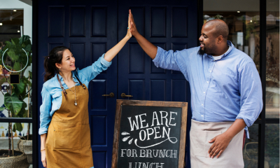 Cafe owners celebrating opening day