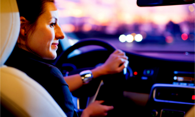 A sales executive drives her company car home from a meeting with a client.