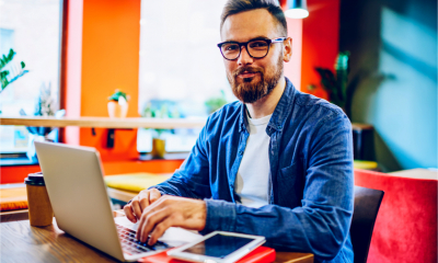 An attractive young man works on his laptop
