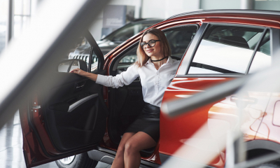 A woman in a new car showroom