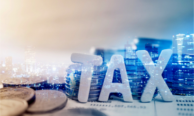 A visual representation of corporation tax with the word tax against a city backdrop