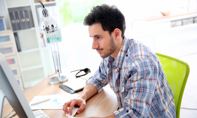 A young man writes freelance copy to make some extra cash