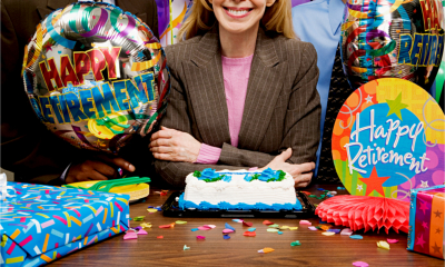 An older female employee celebrates her retirement with her colleagues