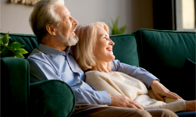 An older couple relax on the sofa
