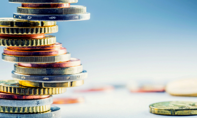 A stack of foreign currency coins on a table