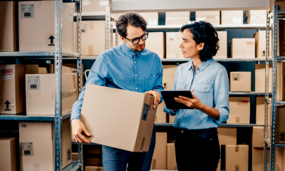 Two business owners look at their export order list