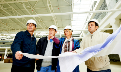 Financing equipment Group of people in hard hats on building site