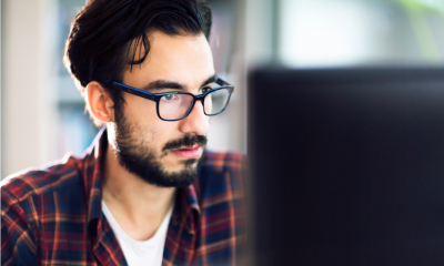 Man with glasses and red flannel shirt looks to find financial business support