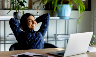 A relieved woman smiles as she submits her self assessment tax return