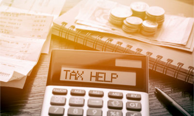 A calculator with the words Tax Help written on the display