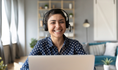 Happy worker in front of their laptop working from home