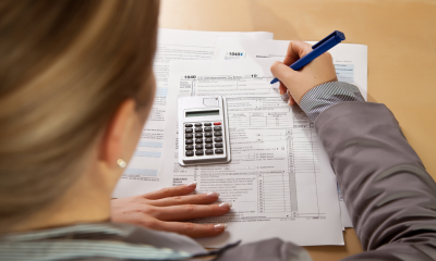 A lady sitting and her desk doing her tax
