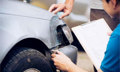 An insurer inspects the damage to a customer's car