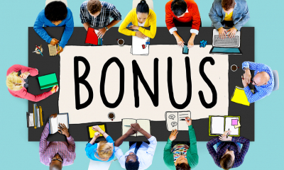 Introducing an incentive pay scheme - checklist People sitting around a large table with the word bonus written on it viewed from above