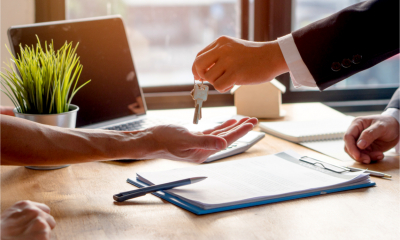A landlord hands over the keys to a rental property