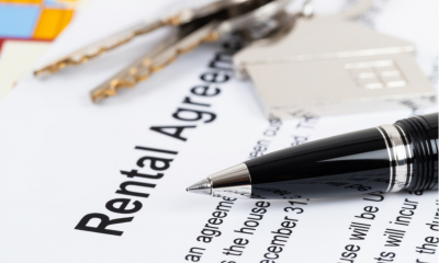 Keys and a pen resting on top of a rental agreement