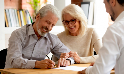 A happy, older couple receive financial planning advice