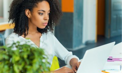 Young female business women learning of new insolvency rules on her laptop