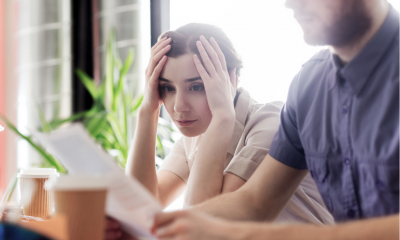Businesswoman looking at documents with worry
