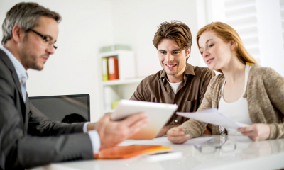 Overdrafts and bank loans Smiling business owners arranging loan with bank manager
