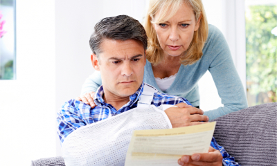 Couple reading a letter from the insurance company about husband's injury