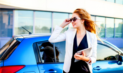 Woman next to company car
