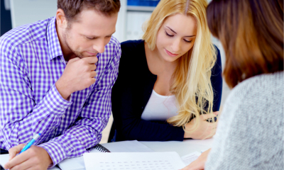 Bank manager discussing business loan repayments with business owners