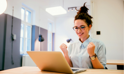 A woman celebrates successfully claiming her National Insurance rebate