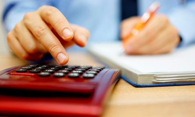 Man calculating whether to take a salary or dividends from his business