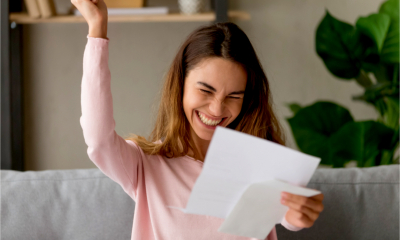 An attractive women celebrates receiving confirmation of her tax refund
