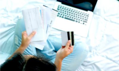 An overhead shot of a woman holding a pile or receipts as she claims research and development expenditure credits