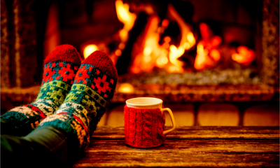 A man relaxes in front of the fire as the self assessment return has been completed