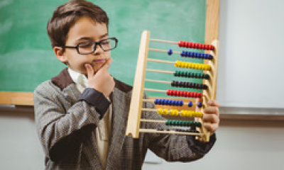 A child uses an abacus to solve a problem