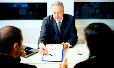 Subsidised and guaranteed loans Bank manager explaining loan paperwork