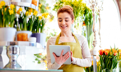 A florist checks her payments using the SumUp app