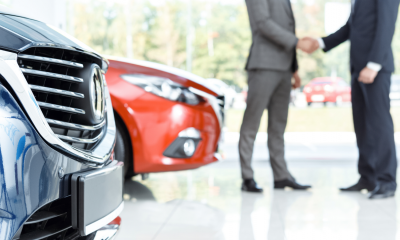 A car dealer shaking hand with a man who has leased a car